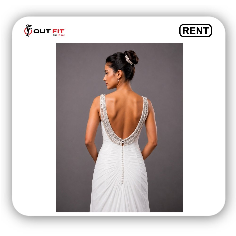 Close-up of crystal beaded scoop back on white bridal gown on rent in Bangalore with fabric button track Close-up of crystal beaded scoop back on white bridal gown on rent in Bangalore with fabric button track