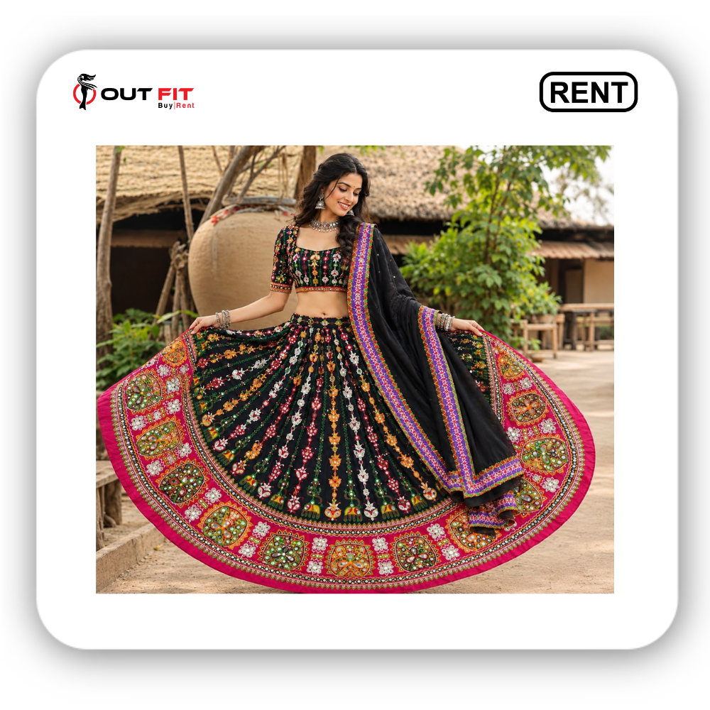 Woman wearing black mirror work garba dress for rent in Bangalore with multi-color embroidery - Close-up of traditional mirror work and vibrant pink border on garba lehenga skirt in Bangalore